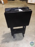 Set of black tray tables on stand