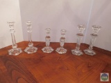 Three sets of clear glass candlesticks