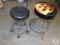 Lot of 2 Black Stools 1 with Casters, 1 with Flames