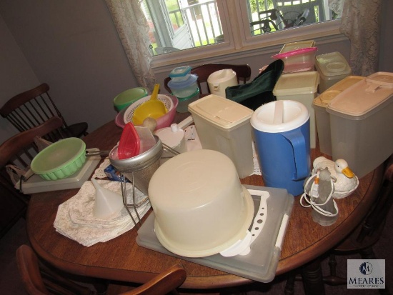 Contents of kitchen table Tupperware containers pictures colanders and linens