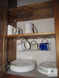 Contents of kitchen cabinets includes china mugs plates bowls and saucers