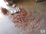 Lot of drop cords and 100 foot measuring tape and gas can