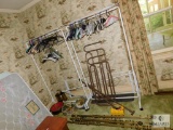 Lot portable clothes racks (2) with hangers, curtain rods, and vintage tins