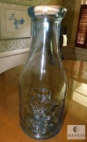Large heavy glass jug approximately 2 ft tall embossed milkcow 1890