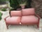 Wood outdoor love seat couch with red cushions