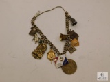 unmarked Gold & silver tone charm bracelet with various charms