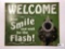 Welcome Now Smile Tin Sign