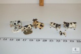 Tiny Holstein cow figurines, some porcelain