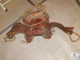 Old Vintage Western Style Horse Saddle with Wood Stirrups, Lasso Rope, and Girth Belt