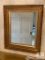 Mirror with gold-colored wooden frame