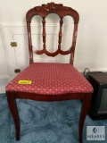 Wood dining chair with red upholstered seat