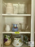 Contents of kitchen cabinet - various pitchers