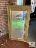 Gold-colored framed mirror