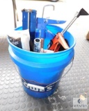 Bucket of Caulk Guns and Paint Rollers