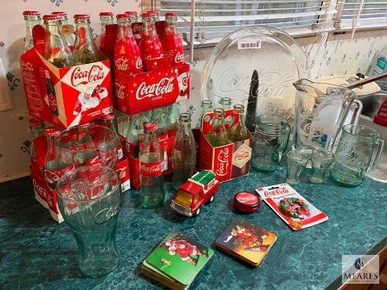 Assorted Coca-Cola Bottles, Glasses, and Serveware
