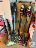 Group of Shark Vacuum Cleaners and Bissell Floor Cleaner