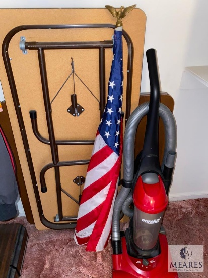 Four-foot Folding Table, American Flag and Vacuum with Shelf Contents