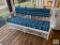 Older Wicker Sofa with Blue and White Cushion