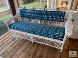 Older Wicker Sofa with Blue and White Cushion