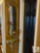 Small Mirror and Wall Sconce with Floral Arrangement