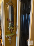 Small Mirror and Wall Sconce with Floral Arrangement