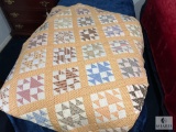 Vintage Patchwork Quilt with Soft Peach and Earth-Tone Patterns