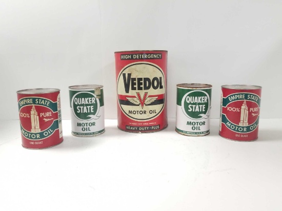 Group of antique oil petroleum cans. Featuring a large Veedol motor oil can, two Quaker State cans,