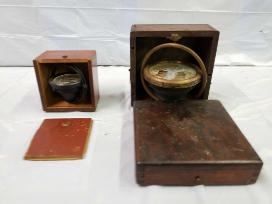 Pair of antique ship compasses in wooden boxes. See photos for details.