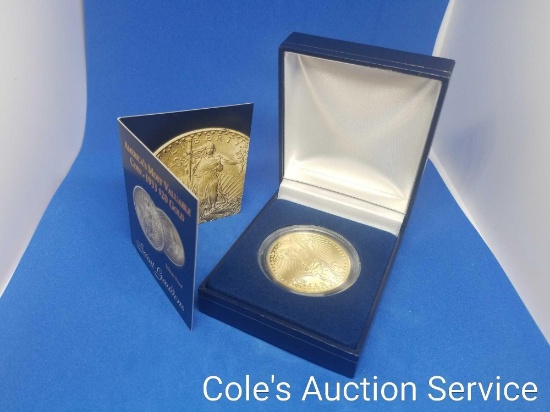 Replica $20 gold coin in display box.