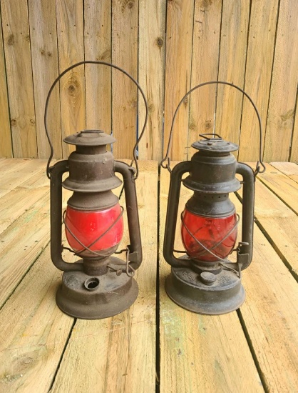 Pair of railroad themed red glass lanterns. both look to be in good condition, the one on the right