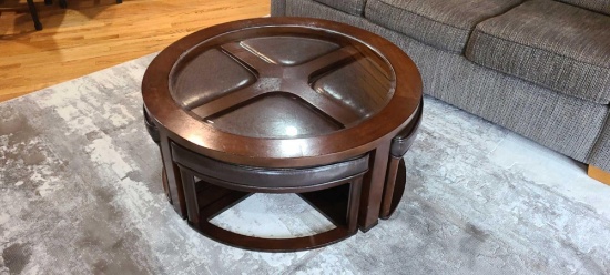 Modern round table that measures approximately 40 in in diameter and 17 in tall. Unique design