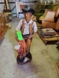 Cowboy Holding Saddle Statue