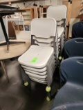 2 Stacks of White Plastic Stacking Chairs