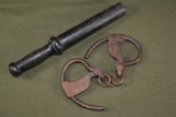 Antique policeman’s handcuffs and billy club.