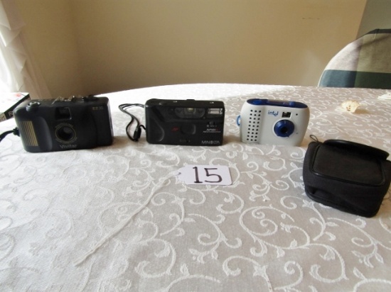 Two 35mm Cameras And A Digital Camera