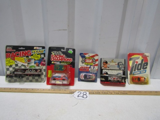 Four N I B Die Cast Metal Race Cars And A Hauler