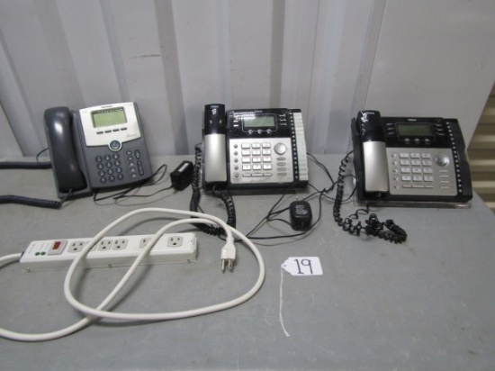3 Land Line Business Telephones And A Belkin Power Strip