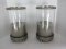 Pair - Footed Metal Base Pillar Candle Stands w/ Cylindrical Glass Hurricane Shade