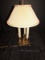 Twin Light Lamp Ornate Brass Base 3 Candlestick Motif w/ Tan Trim Shade w/ Handle