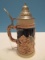 Western Germany Beer Stein w/ Lid Relief Design Couple Cabins & Mountain Background