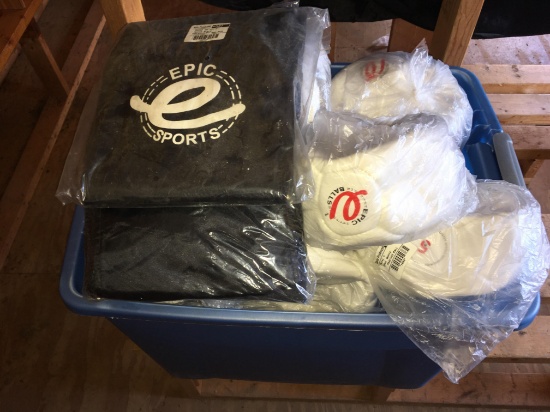 Bin of unused soccer balls and two soccer bags.