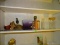 SHELF LOT. INCLUDES A SMALL CARDINAL PAPER WEIGHT, A PURPLE TISSUE BOX COVER, A JULIE UELAND 