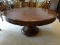 LARGE SINGLE PEDESTAL ROUND INLAID DINING TABLE WITH 1 LEAF (24'' WIDE). HAS A CARVED SKIRT. BASE