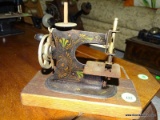 ANTIQUE STENCILED CHILDS SEWING MACHINE. MADE IN GERMANY. ON WOODEN BASE: 7