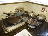 CONTENTS ON COUNTER BY SINK: LARGE AMOUNT OF POTS AND PANS. SOME CUISINART. 6 PIECES OF CALPHALON.