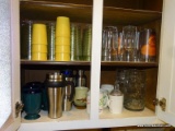 CONTENTS OF CABINET: ICE TEA GLASSES. LEMONADE PITCHER. COFFEE CUPS AND MUGS. STAINLESS STEEL COFFEE