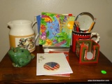 CONTENTS ON TOP OF CABINET: WOODLAND CELEBRATION WATER PITCHER. POTTERY FROG TAPE DISPENSER. NAPKIN