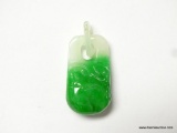 27.41 CT. CARVED BI COLOR JADE. MEASURES APPROX. 32 BY 15 BY 9MM.