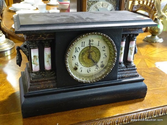 (W1) ANTIQUE MANTLE CLOCK WITH KEY AND PENDULUM. IN FAUX GRAINED CASE WITH PORCELAIN COLUMNS WITH