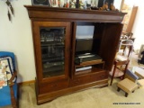 (LR) BROWN WALNUT FINISH ENTERTAINMENT CENTER 60''X22''X59'' HAS POCKET DOORS THAT FOLD IN. CAPABLE